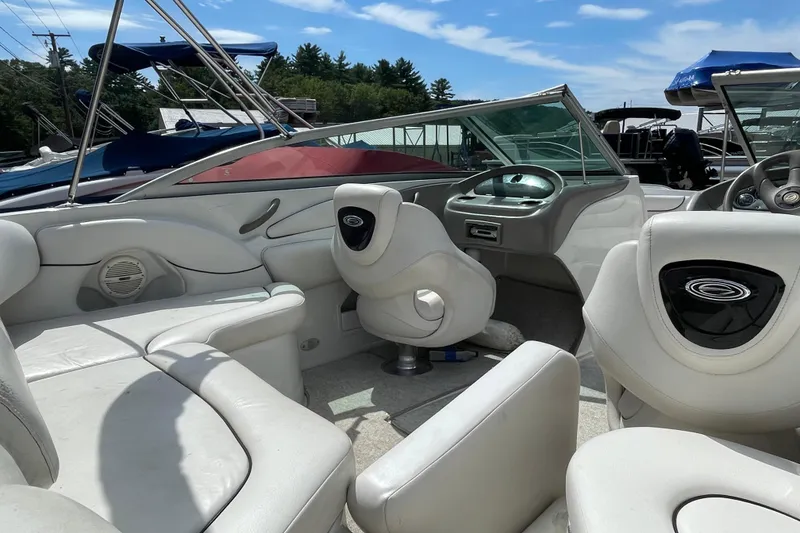 Slide: The Image of Interior of a 2004 Crownline 216 LS boat with white seating and dashboard. - 13