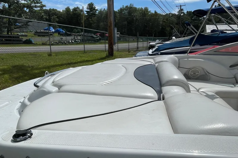 Slide: The Image of 2004 Crownline 216 LS boat interior with white leather seating and outdoor view. - 4