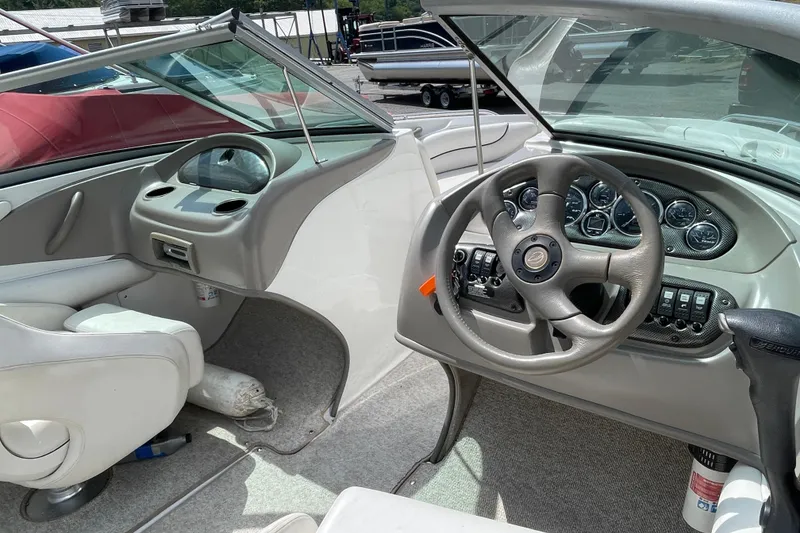 Slide: The Image of 2004 Crownline 216 LS boat interior with steering wheel and dashboard controls. - 5