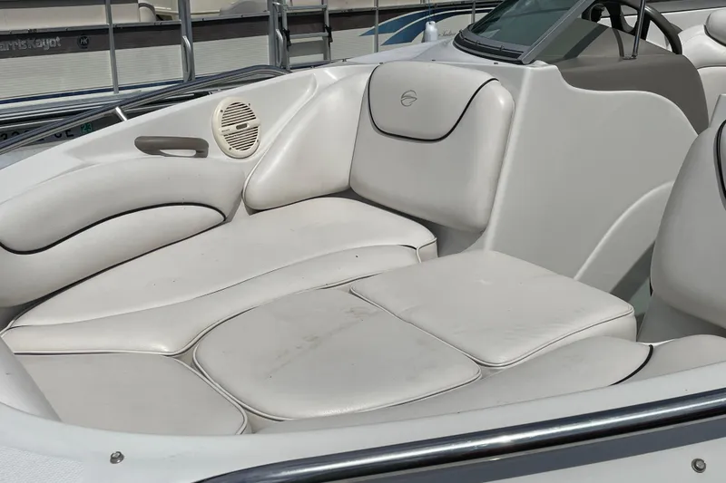 Slide: The Image of 2004 Crownline 216 LS boat interior with white cushioned seating and speaker. - 6