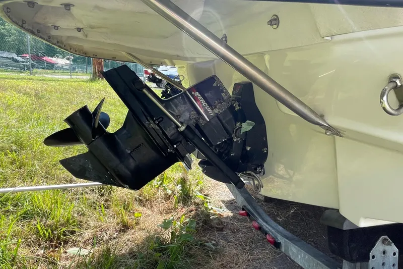 Slide: The Image of 2004 Crownline 216 LS boat stern drive and propeller in grassy outdoor setting. - 7