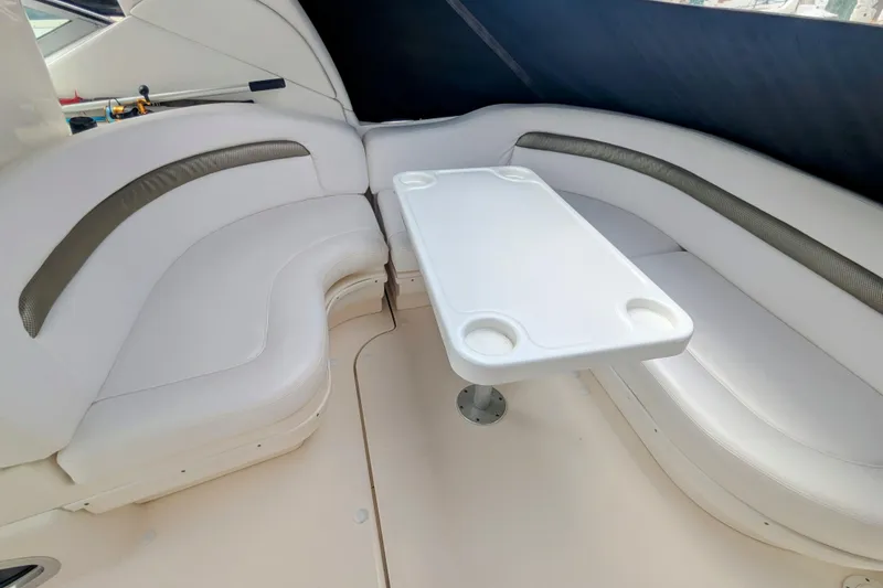 Slide: The Image of 2004 Sea Ray 340 Sundancer interior with white seating and table. - 15