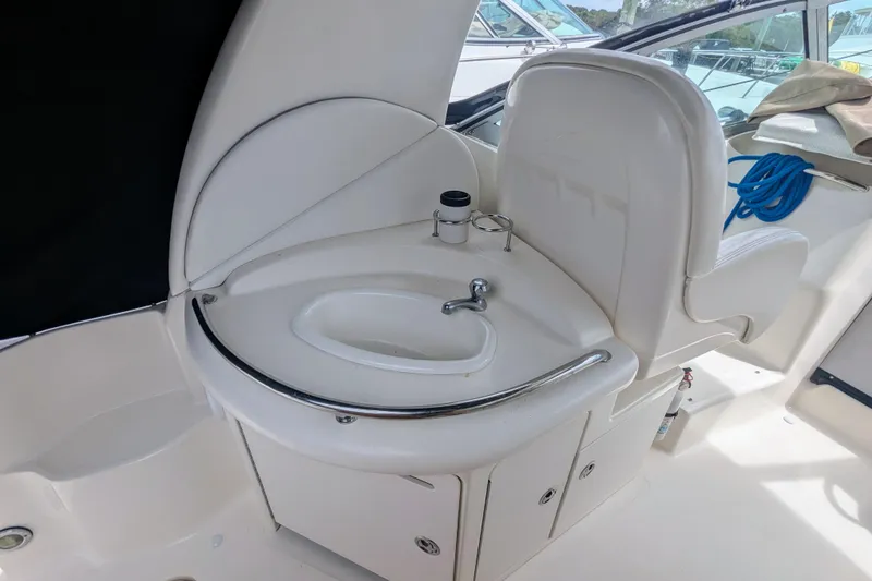 Slide: The Image of 2004 Sea Ray 340 Sundancer cockpit sink and seating area. - 17