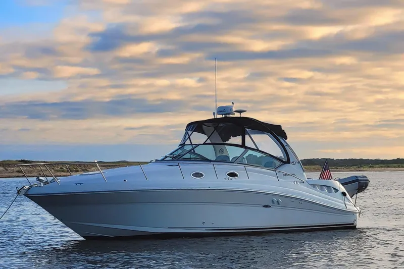 Slide: The Image of 2004 Sea Ray 340 Sundancer yacht on calm water at sunset. - 2