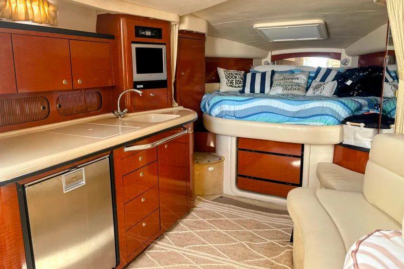 Slide: The Image of Luxurious 2004 Sea Ray 340 Sundancer cabin with kitchenette and cozy sleeping area. - 20