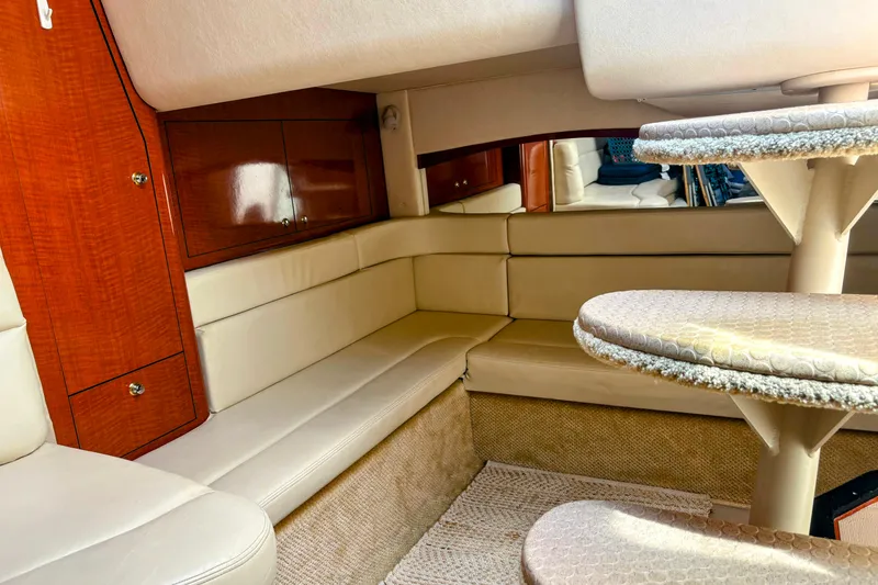 Slide: The Image of Luxurious interior of 2004 Sea Ray 340 Sundancer yacht with beige seating and wooden cabinetry. - 26