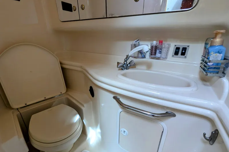Slide: The Image of 2004 Sea Ray 340 Sundancer bathroom with sink, toilet, and toiletries. - 28