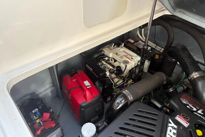Slide: The Image of Engine compartment of a 2004 Sea Ray 340 Sundancer with visible components and wiring. - 34