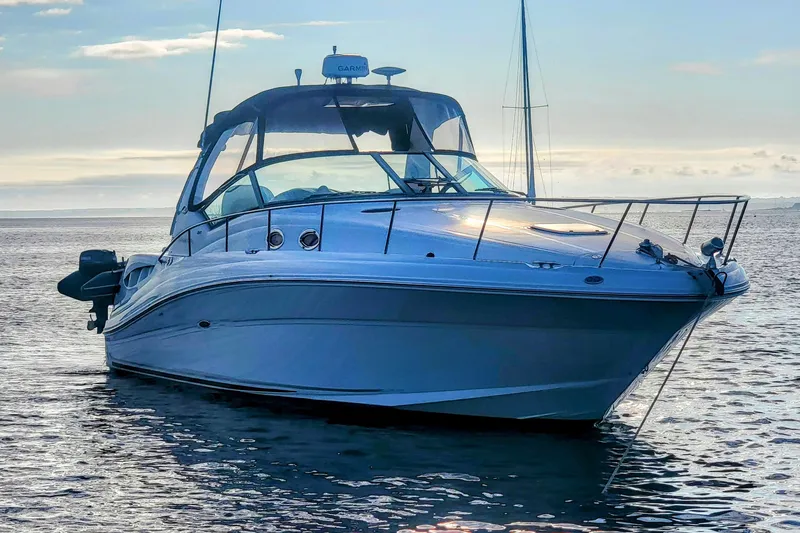 Slide: The Image of 2004 Sea Ray 340 Sundancer yacht on calm water at sunset. - 5