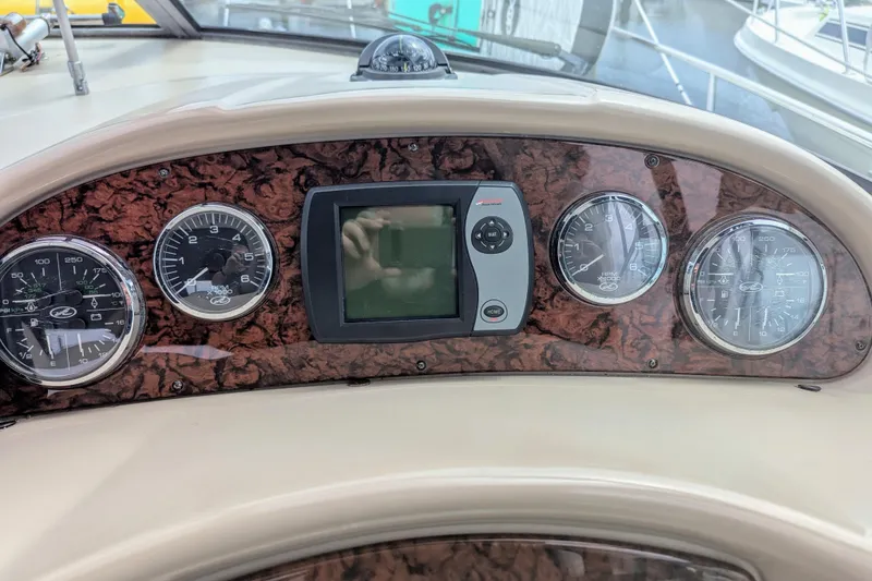 Slide: The Image of Dashboard of 2004 Sea Ray 340 Sundancer with gauges and navigation display. - 8