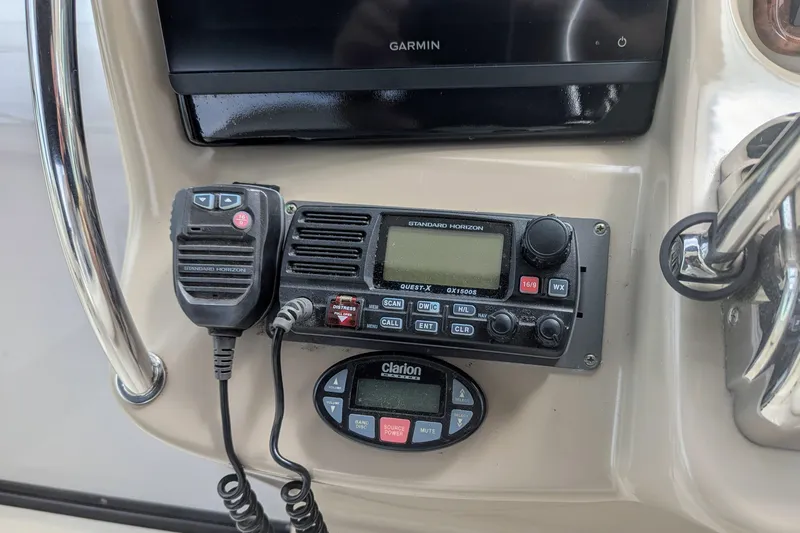 Slide: The Image of 2004 Sea Ray 340 Sundancer dashboard with Garmin, Standard Horizon radio, and Clarion controls. - 9