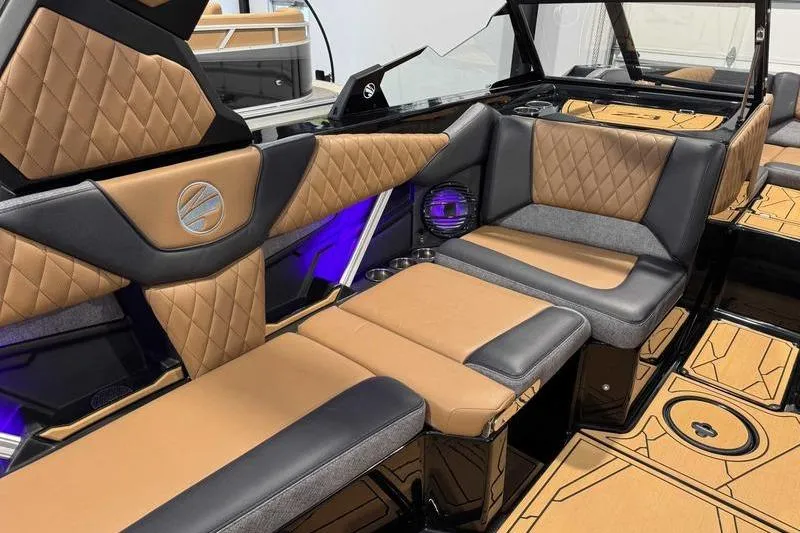 Slide: The Image of Luxurious interior of 2026 Tigé Z3 boat with tan and black seating. - 10
