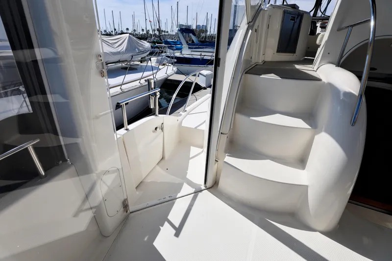 Slide: The Image of 2005 Meridian 459 Aft Cabin Motor Yacht interior with stairs and marina view. - 12