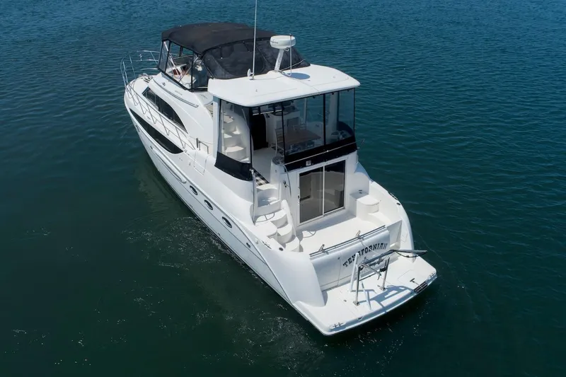 Slide: The Image of 2005 Meridian 459 Aft Cabin Motor Yacht cruising on calm blue waters. - 2