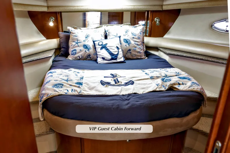 Slide: The Image of VIP guest cabin in 2005 Meridian 459 Aft cabin motor yacht, featuring nautical-themed bedding. - 23