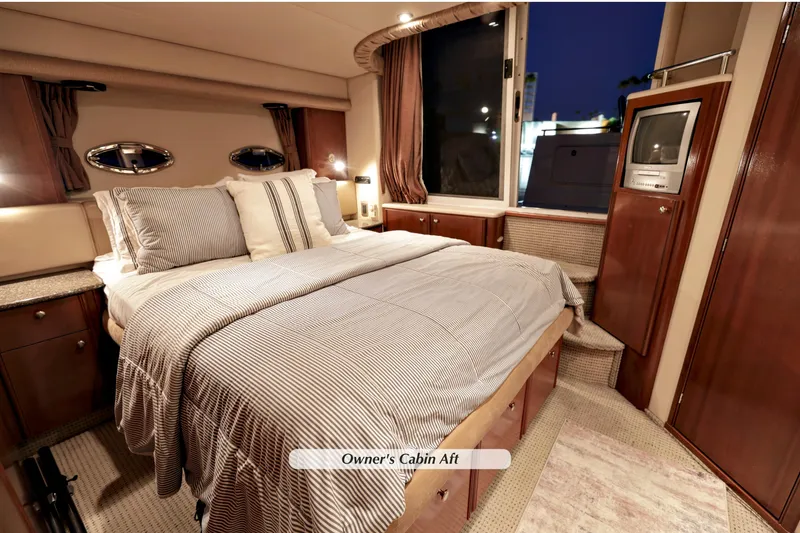 Slide: The Image of Luxurious 2005 Meridian 459 yacht owner's cabin with elegant bedding and wood cabinetry. - 25