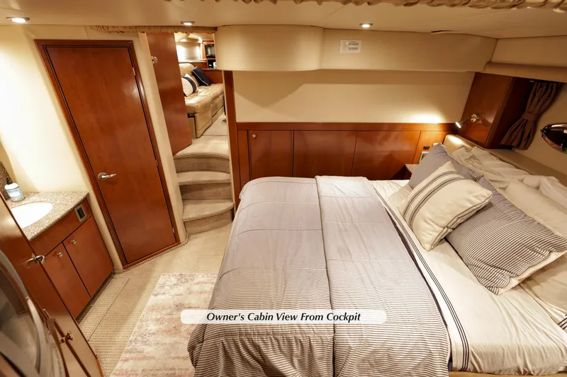 Slide: The Image of Luxurious 2005 Meridian 459 yacht cabin with elegant bedding and wood finishes. - 26