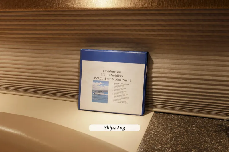 Slide: The Image of Blue binder labeled "Texafornian 2005 Meridian 459 Cockpit Motor Yacht" on a yacht interior. - 28
