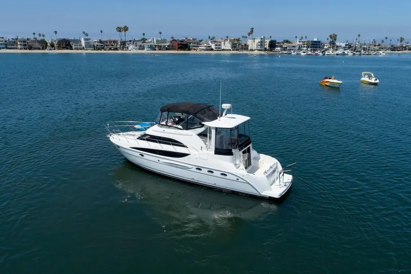 Slide: The Image of 2005 Meridian 459 Aft Cabin Motor Yacht cruising in a scenic coastal area. - 3