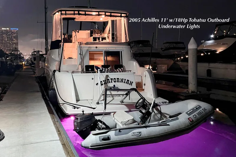 Slide: The Image of 2005 Meridian 459 Aft Cabin Motor Yacht with Achilles dinghy and underwater lights at night. - 30