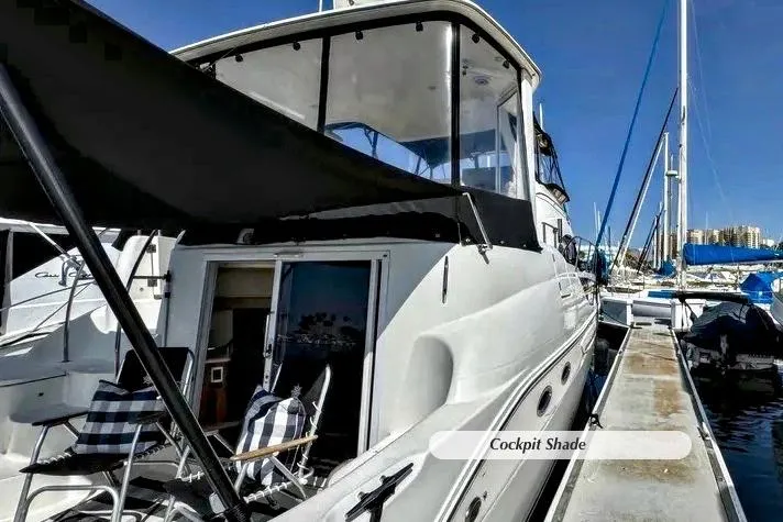 Slide: The Image of 2005 Meridian 459 Aft Cabin Motor Yacht docked with cockpit shade. - 32