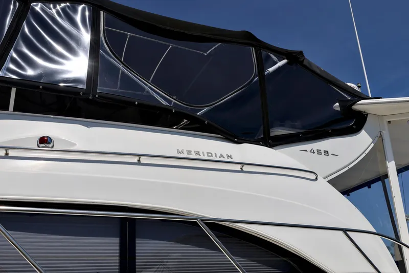 Slide: The Image of 2005 Meridian 459 Aft Cabin Motor Yacht with sleek design and black canopy. - 6