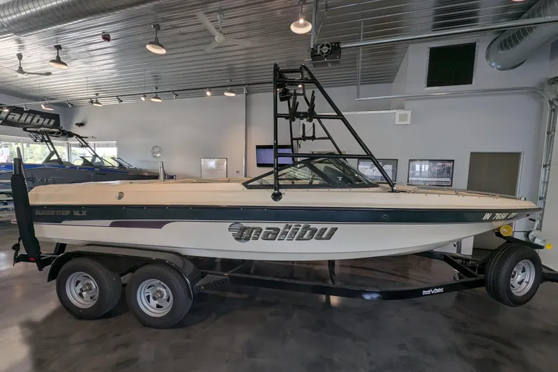The Image of 2000 Malibu Sunsetter VLX boat on trailer in showroom. - 1