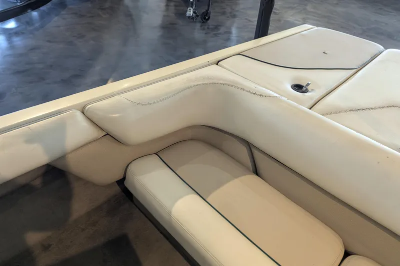 Slide: The Image of 2000 Malibu Sunsetter VLX boat interior with white leather seating and storage compartment. - 13