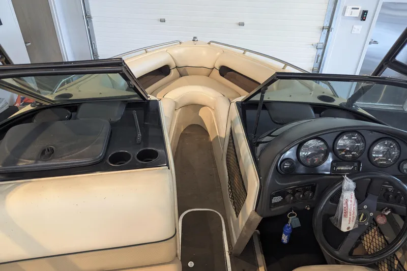 Slide: The Image of Interior view of a 2000 Malibu Sunsetter VLX boat with dashboard and seating area. - 14