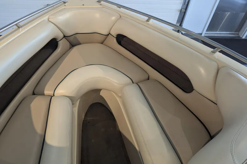 Slide: The Image of 2000 Malibu Sunsetter VLX boat interior with beige cushioned seating. - 16