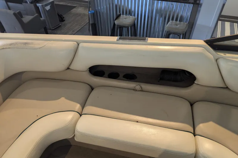 Slide: The Image of Interior seating of a 2000 Malibu Sunsetter VLX boat with beige upholstery. - 17
