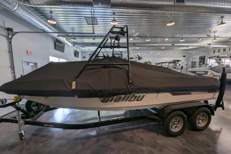 Slide: The Image of 2000 Malibu Sunsetter VLX boat with cover on trailer in showroom. - 25