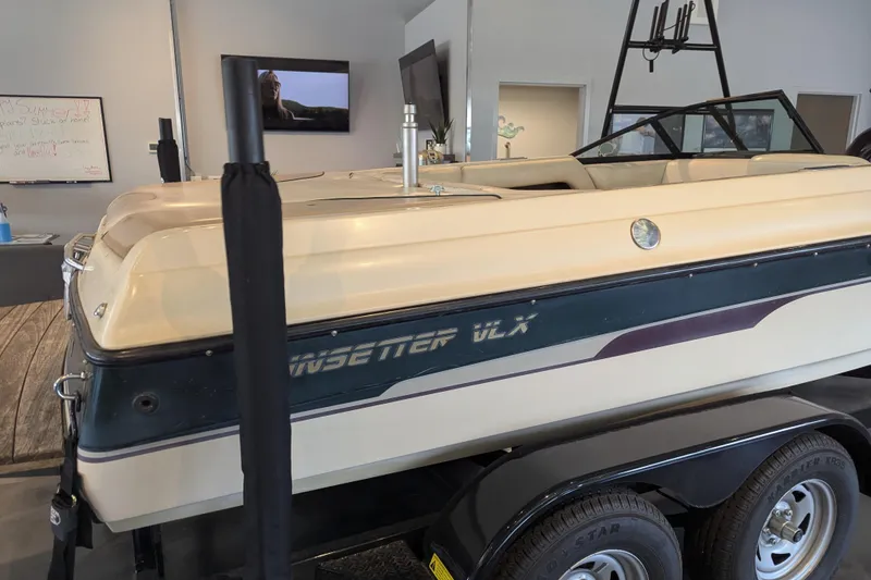 Slide: The Image of 2000 Malibu Sunsetter VLX boat on trailer in showroom setting. - 3