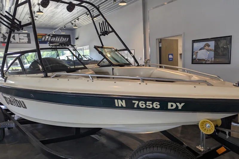 Slide: The Image of 2000 Malibu Sunsetter VLX boat displayed indoors on a trailer. - 9