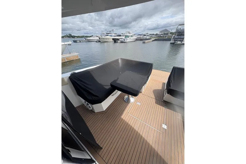 Slide: The Image of 2017 Cruisers Yachts 39 Express Coupe deck with covered seating, docked at marina. - 12