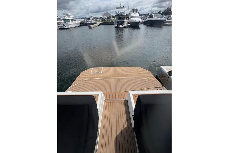 Slide: The Image of 2017 Cruisers Yachts 39 Express Coupe docked, showcasing sleek design and spacious deck. - 14