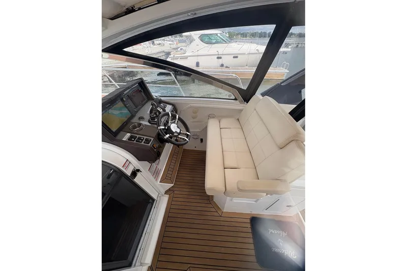 Slide: The Image of 2017 Cruisers Yachts 39 Express Coupe helm with navigation screens and steering wheel. - 22
