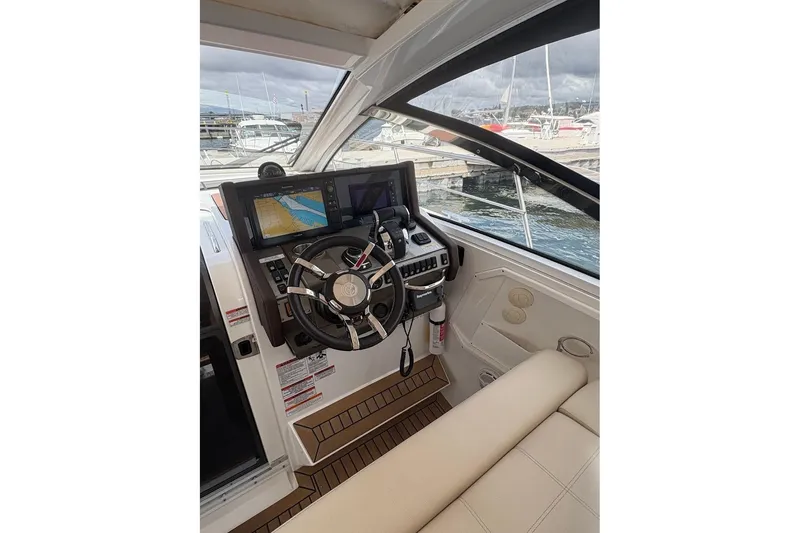 Slide: The Image of 2017 Cruisers Yachts 39 Express Coupe helm with navigation screens and controls. - 23
