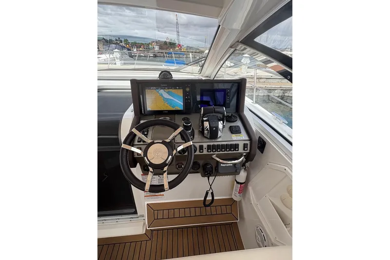 Slide: The Image of 2017 Cruisers Yachts 39 Express Coupe interior with helm, seating, and open sky view. - 24