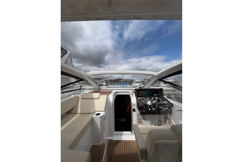 Slide: The Image of 2017 Cruisers Yachts 39 Express Coupe interior with cozy seating and wooden table. - 26