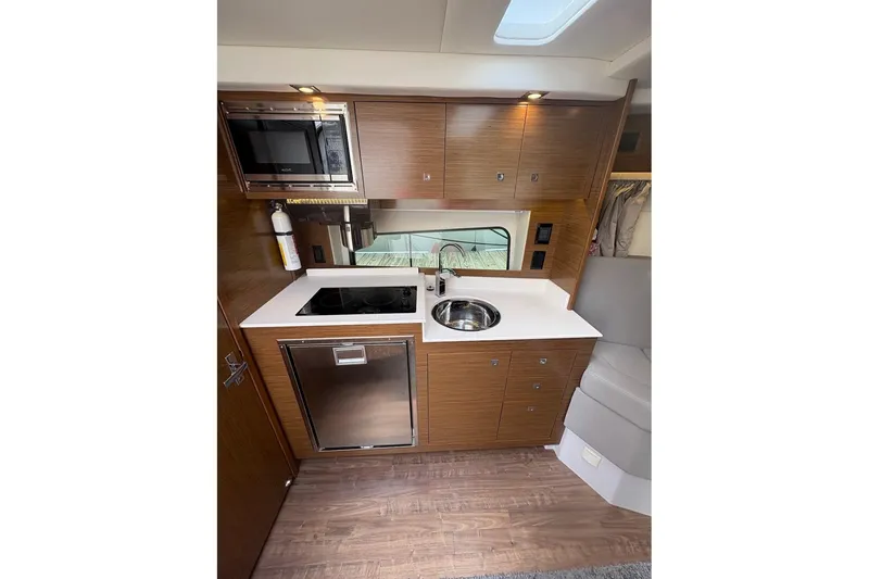Slide: The Image of 2017 Cruisers Yachts 39 Express Coupe cabin with cozy bed and modern wood cabinetry. - 33