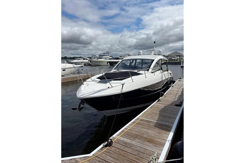 Slide: The Image of 2017 Cruisers Yachts 39 Express Coupe kitchen with modern appliances and wood cabinetry. - 4