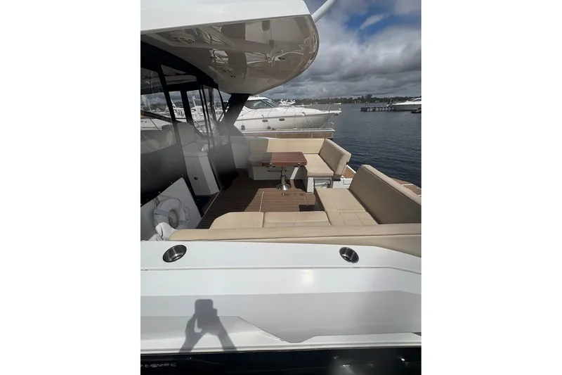 Slide: The Image of 2017 Cruisers Yachts 39 Express Coupe with spacious seating and elegant design on the water. - 6