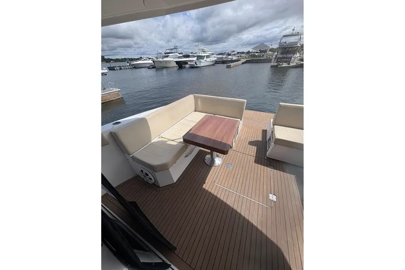 Slide: The Image of 2017 Cruisers Yachts 39 Express Coupe interior with beige seating and wooden flooring. - 8