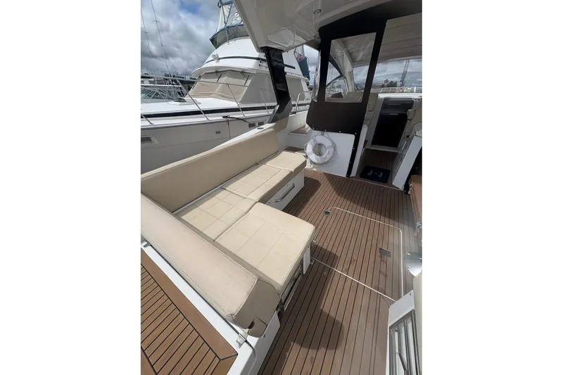 Slide: The Image of 2017 Cruisers Yachts 39 Express Coupe with spacious deck seating at marina. - 9