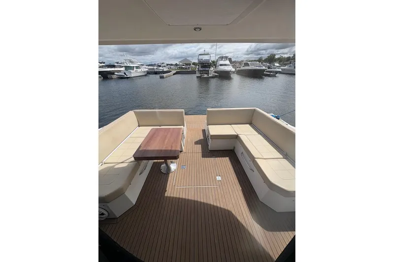 Slide: The Image of 2017 Cruisers Yachts 39 Express Coupe, covered seating on deck, marina view. - 11