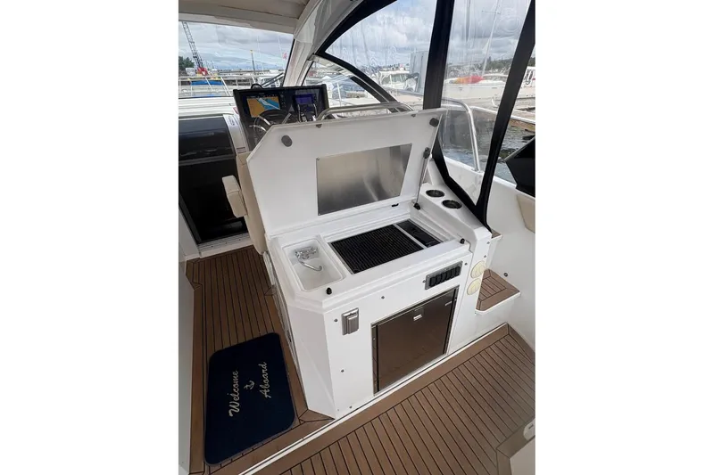 Slide: The Image of 2017 Cruisers Yachts 39 Express Coupe outdoor kitchen with grill and sink. - 16