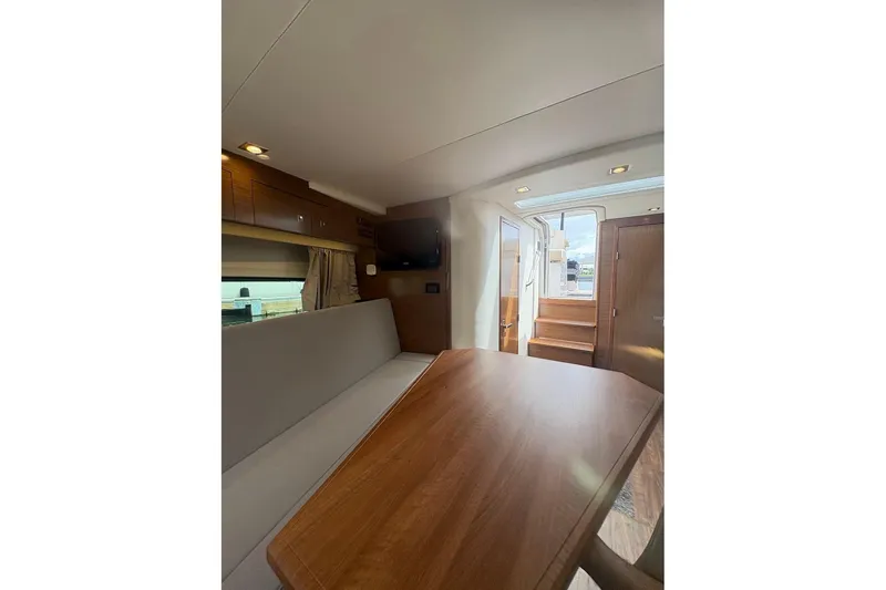 Slide: The Image of 2017 Cruisers Yachts 39 Express Coupe interior with stairs, kitchenette, and cabin view. - 31