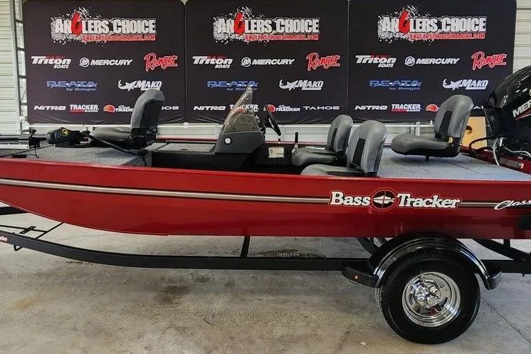 The Image of 2026 Tracker BASS TRACKER® Classic XL boat in showroom, red exterior, Anglers Choice backdrop. - 1