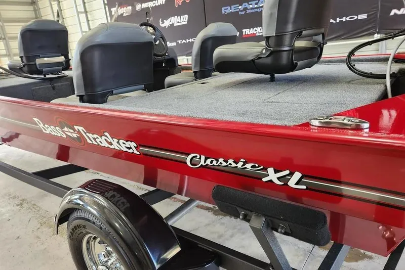Slide: The Image of 2026 Tracker BASS TRACKER® Classic XL boat, red exterior, interior seating, in showroom. - 4